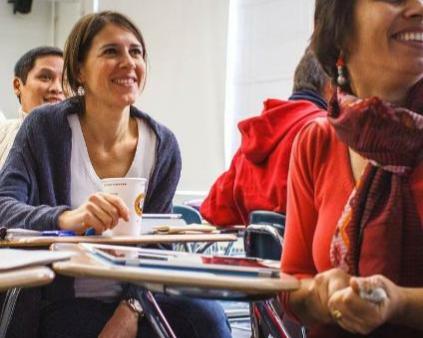 un groupe de femmes souriantes assises dans une salle